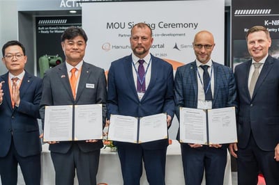 Men in suits signing MOU