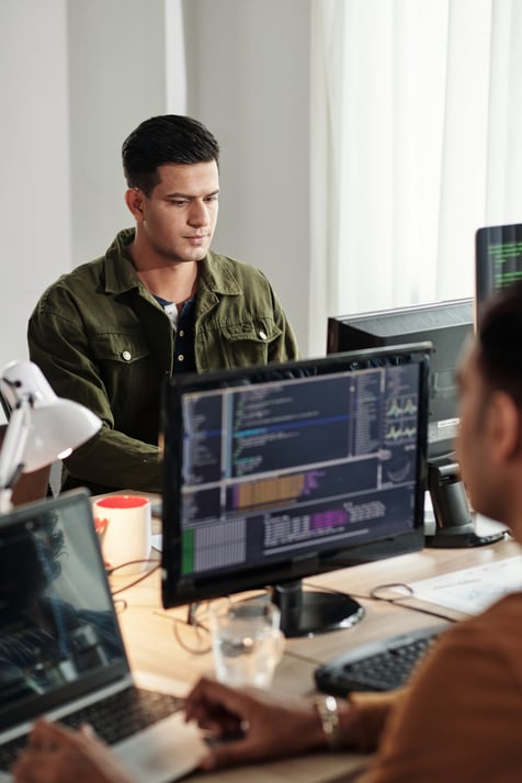 Person sitting infront of a computer writing code