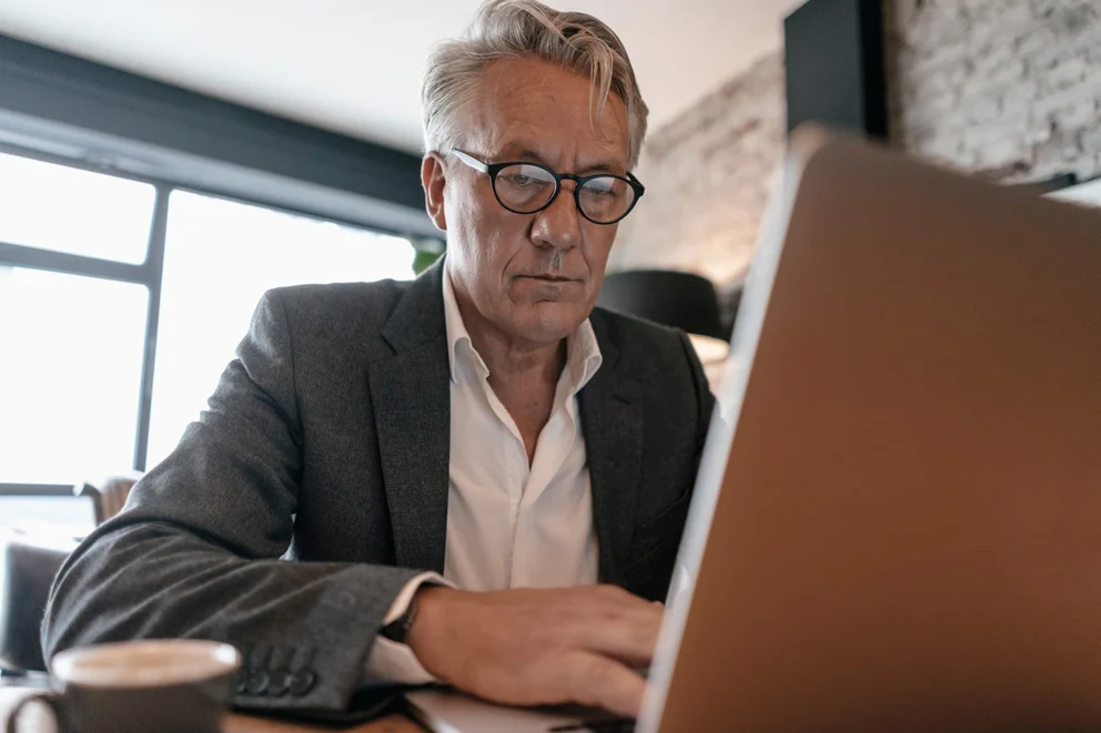 Senior businessman working on a laptop