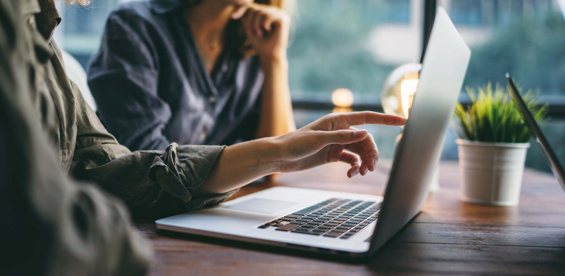 Woman pointing at laptop screen