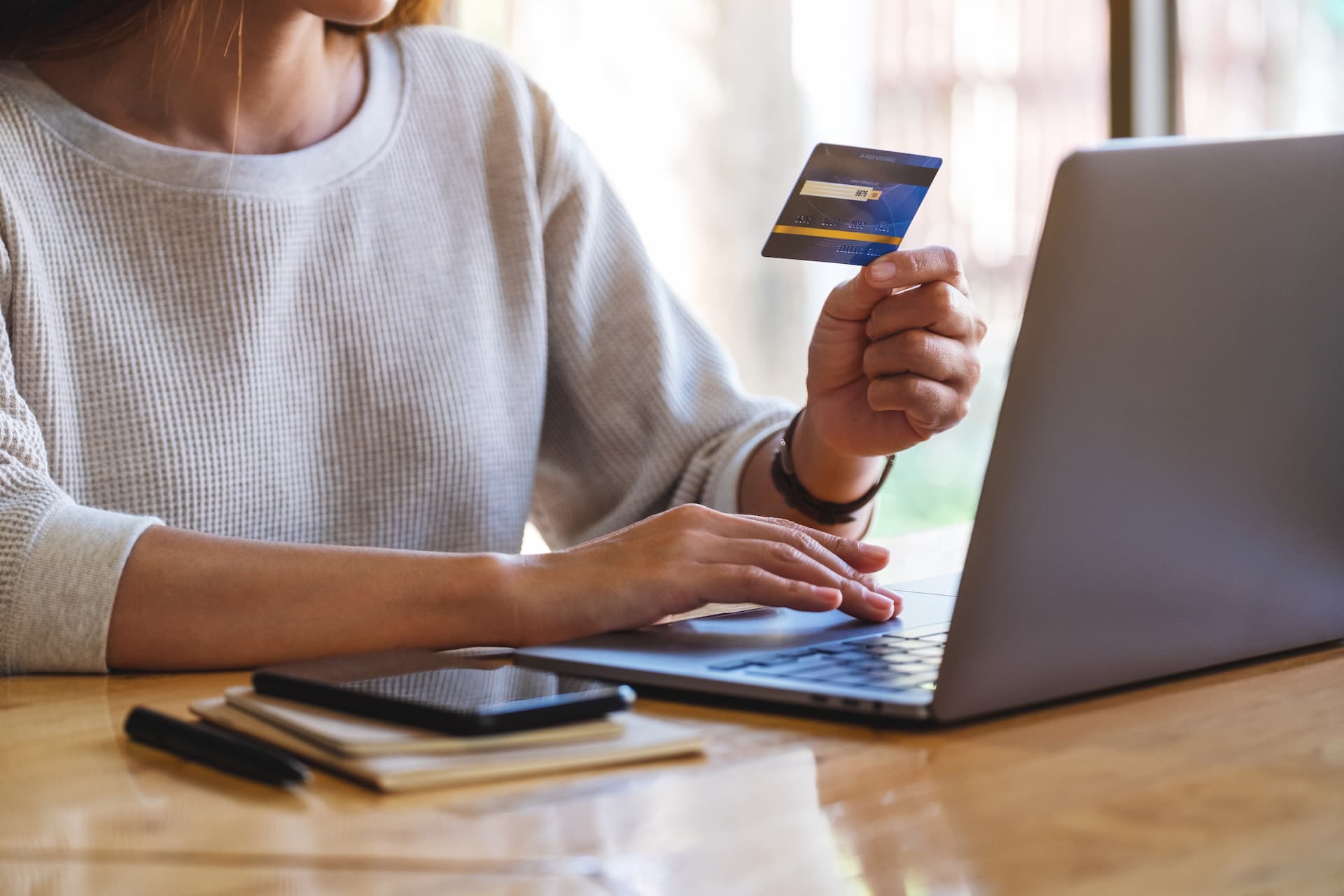 closeup-image-of-a-woman-holding-credit-cards-whil-2026-03-26-22-52-59-utc (1)-1