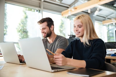 concentrated-young-colleagues-sitting-office-coworking