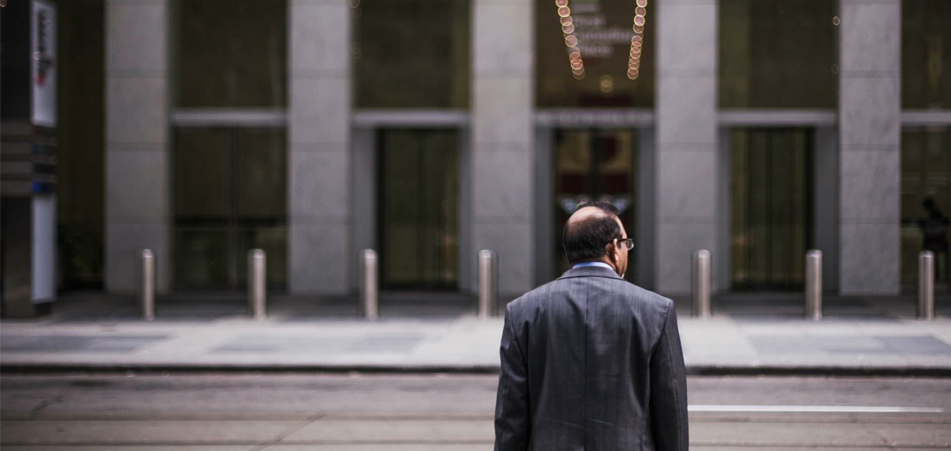 Man crossing the street in front of building
