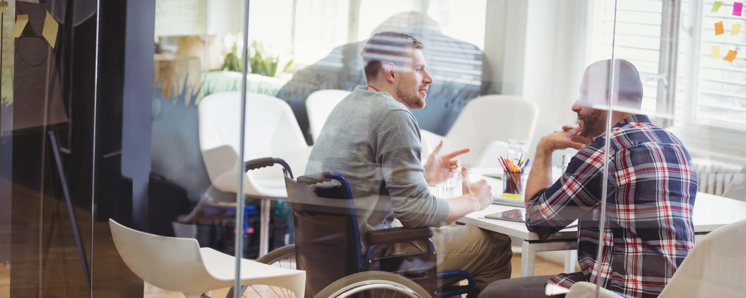 Man with a wheelchair in office