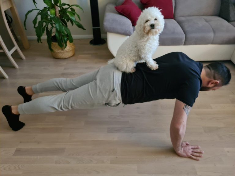 Man doing pushups with dog as part of a Nortal Challenge