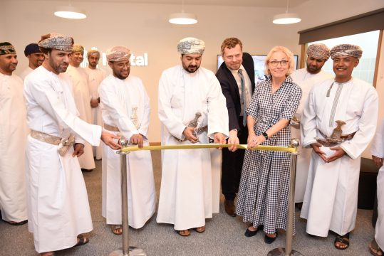 Omani minister and dignitaries cutting ribbon with Nortal leadership